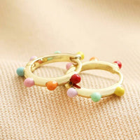 Créoles Huggie à pompons multicolores