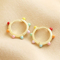 Créoles Huggie à pompons multicolores